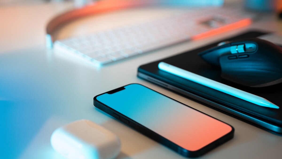 Moderner Arbeitsplatz mit iPhone und AirPods — Telefonische Beratung